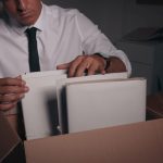 Professional detective doing paperwork in his office, closeup