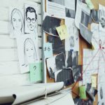 Investigation board on white brick wall in detective office