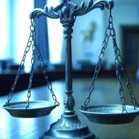 Justice scales in courtroom; legal proceedings; focus on balance; suitable for law articles, educational material, or social media posts. Justice scales in courtroom; legal proceedings; focus on balance; suitable for law articles, educational material, or social media posts.