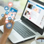 hands-hold-a-smartphone-above-a-laptop